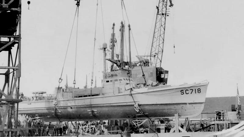 U.S. Navy Subchaser SC 718 swung out toward water by floating crane from deck of Liberty Ship “Willard Hall”. Pollock Dock, Belfast, Northern Ireland, October 7, 1943. SC 718 became a Norwegian Royal Navy vessel, the HNoMS Hitra. During the war the U.S.