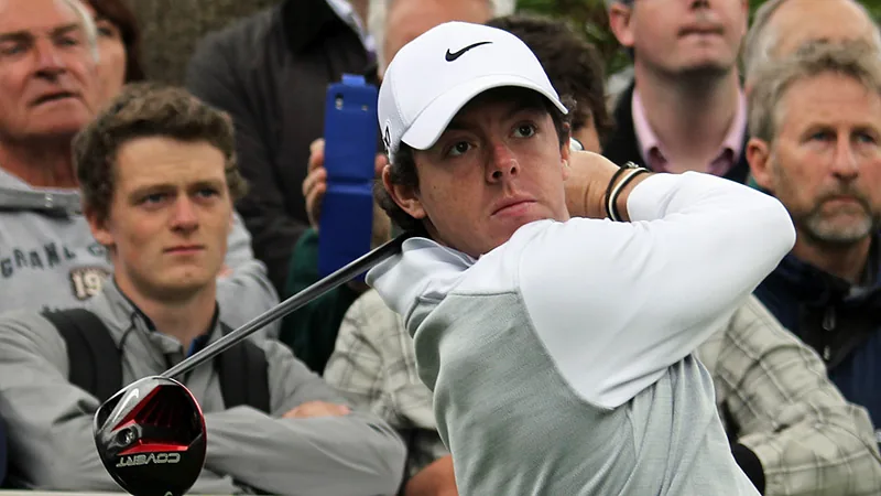 Rory McIlroy watches drive flight (crowd, landscape orientation)